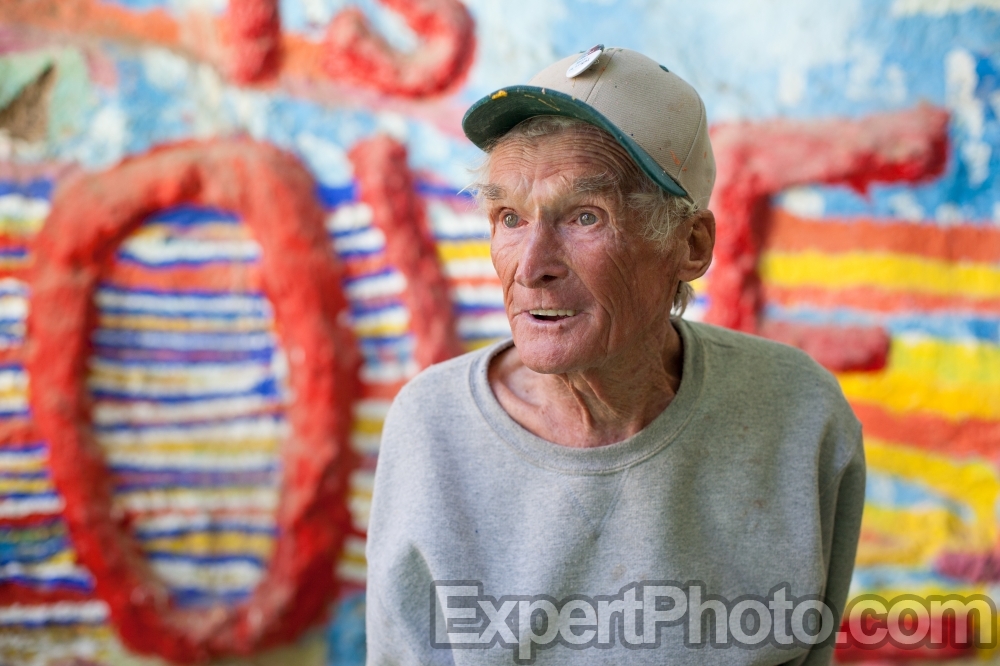 Nice photo of Leonard Knight telling visitors about his Salvation Mountain