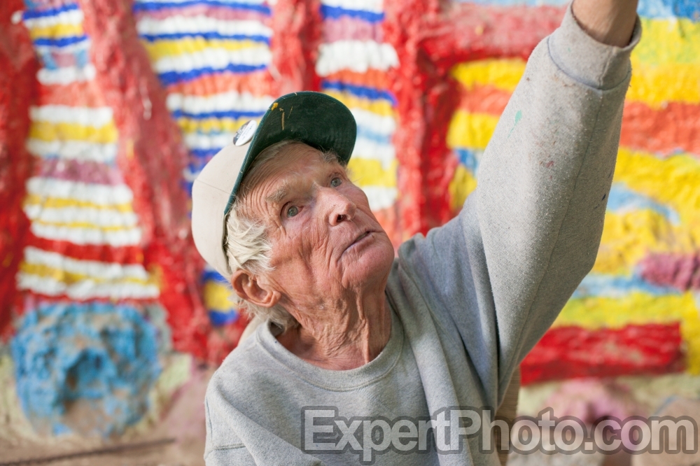 Nice photo of Leonard Knight telling visitors about his Salvation Mountain