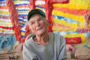 Nice photo of Leonard Knight telling visitors about his Salvation Mountain