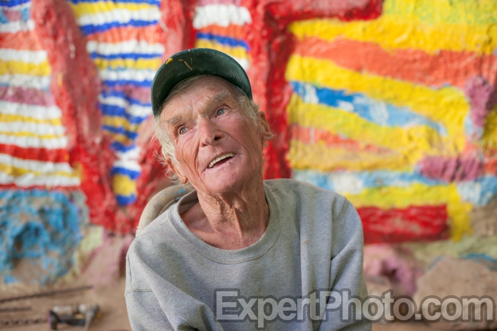 Nice photo of Leonard Knight telling visitors about his Salvation Mountain