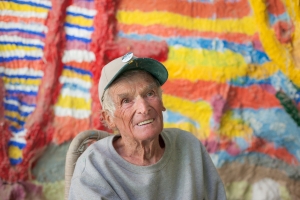 Nice photo of Leonard Knight telling visitors about his Salvation Mountain
