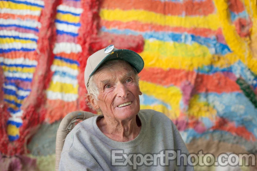 Nice photo of Leonard Knight telling visitors about his Salvation Mountain